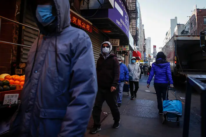 Pedestrians wear face masks in Chinatown on March 16th.